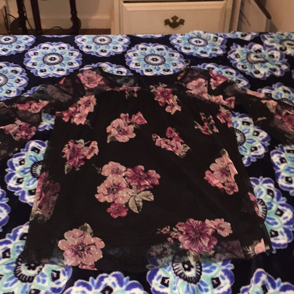 This top has flowers on it & is black.